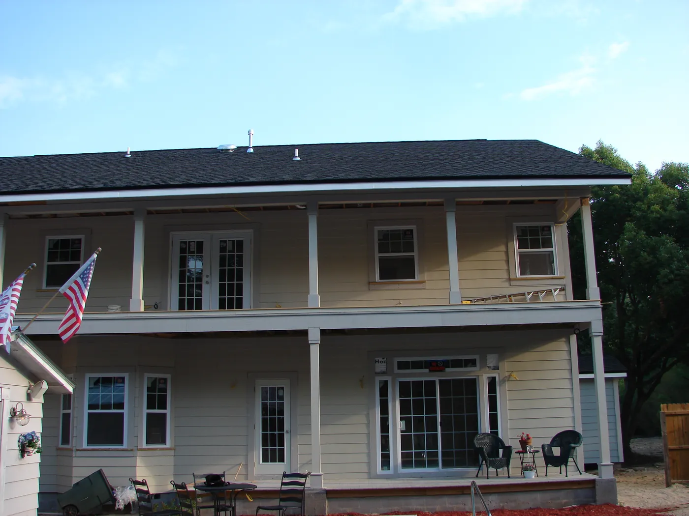 Two-story home exterior with covered front porch and second-floor windows