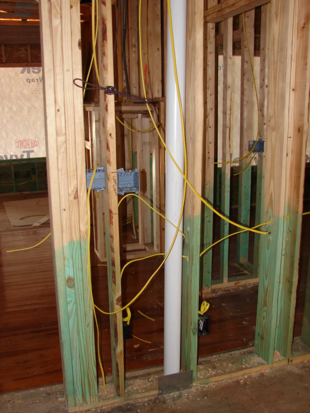 Electrical outlet box and wiring mounted to a wall stud during interior rough-in