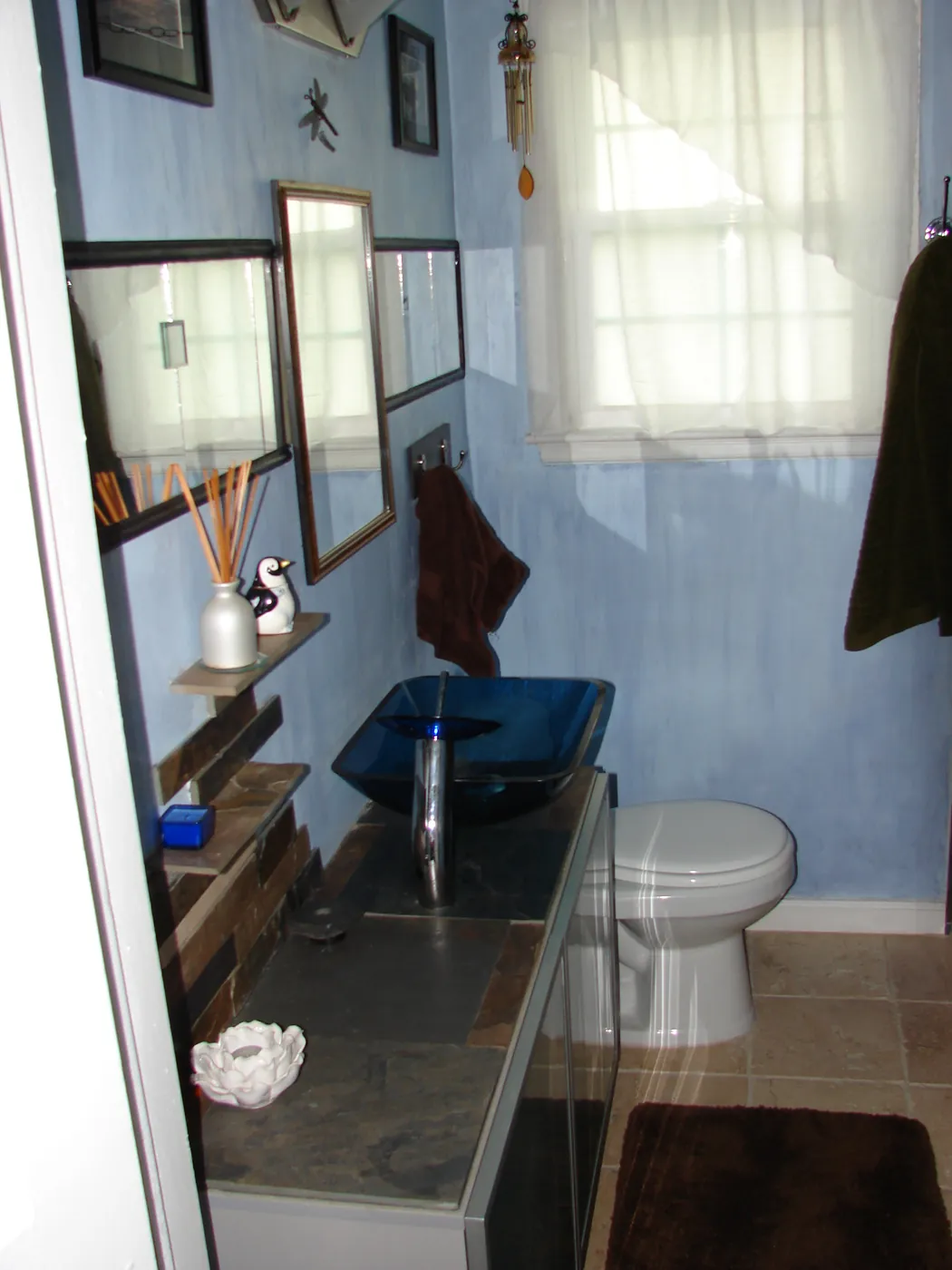 Contemporary bathroom with cobalt blue glass vessel sink, slate-tone walls and vanity mirror