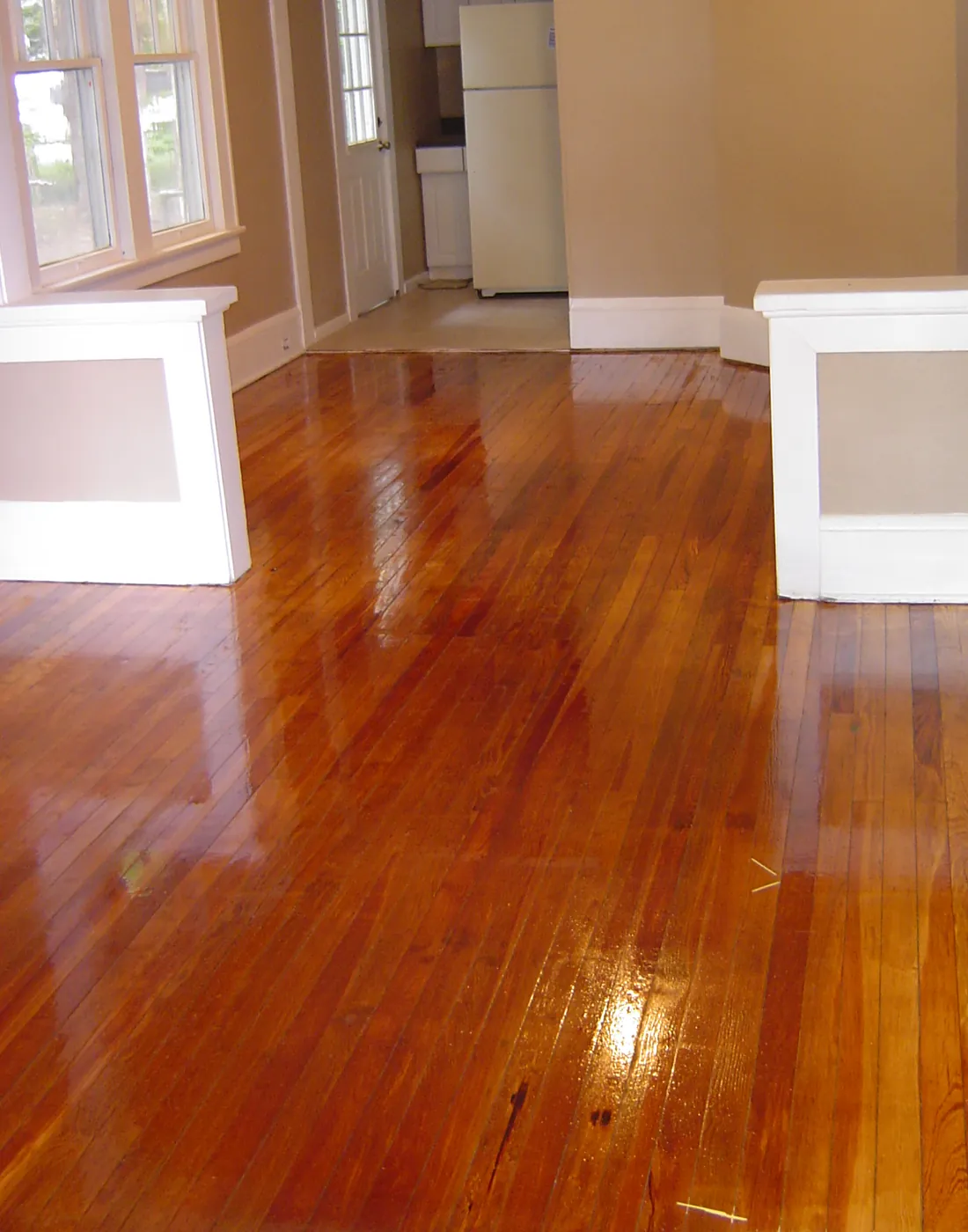 Freshly painted open interior with hardwood floors looking through to the kitchen