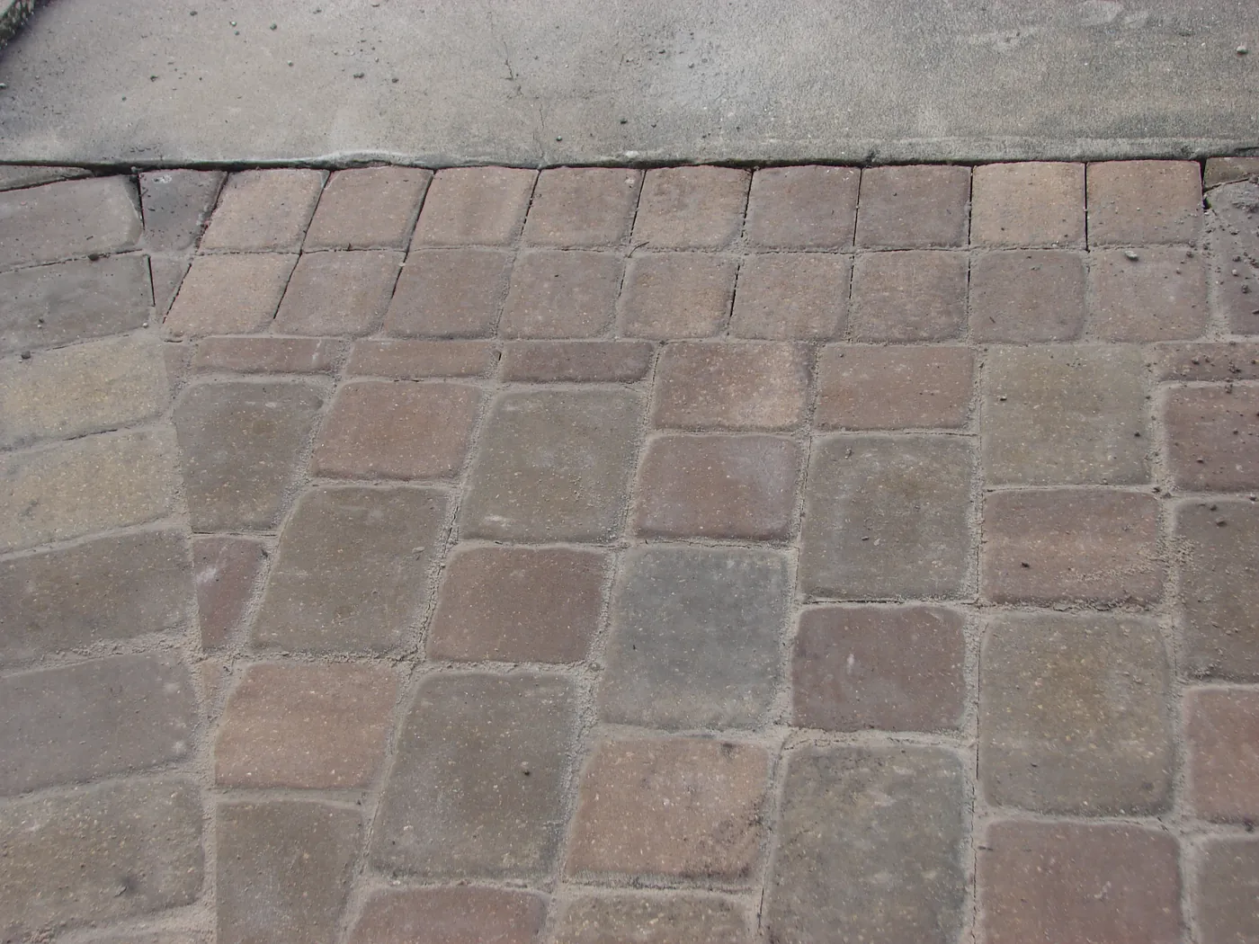 Close-up of a finished brick paver patio laid in a running-bond pattern