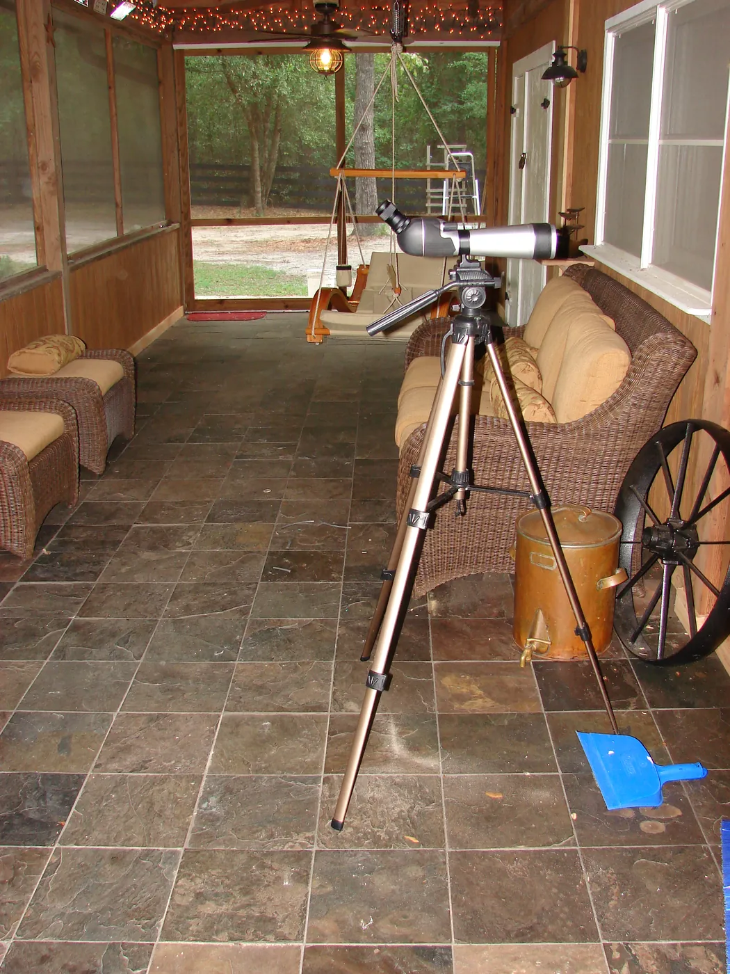 Natural slate stone tile floor in a bright screened sunroom