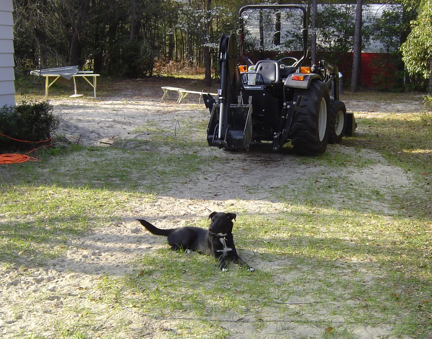 Utility tractor parked on a freshly cleared and mowed open lot