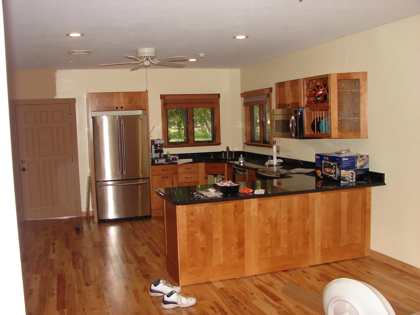 Custom wood kitchen cabinetry and refinished hardwood floors in a restored Northeast Florida home